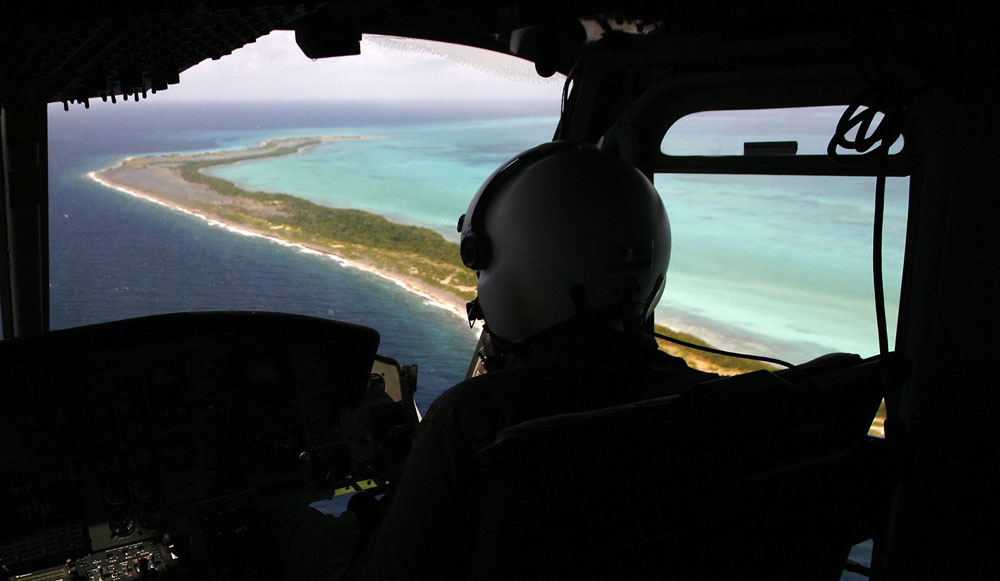 A National Guard plane searches the area near the coral reef where an aircraft disappeared near the Los Roques archipelago